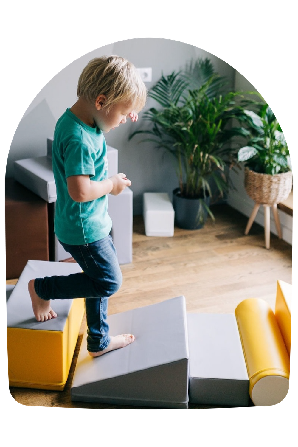 A boy running through a jungle gym made of IGLU soft blocks