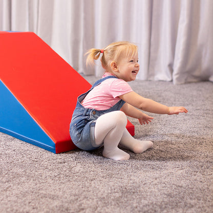 A little girl having fun on an IGLU Soft Play Soft Play Step and Slide Set - Mega Fun Slider obstacle course.