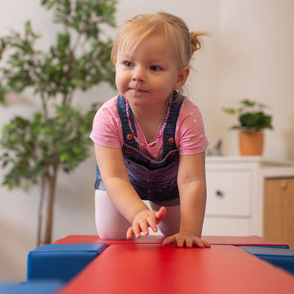 A little girl crawling on an IGLU Soft Play Soft Play Activity Set - Balance Bridge.