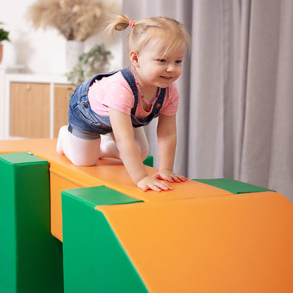 A little girl on a IGLU Soft Play - Soft Play Activity Set - Balance Bridge in a green and orange soft play activity set.