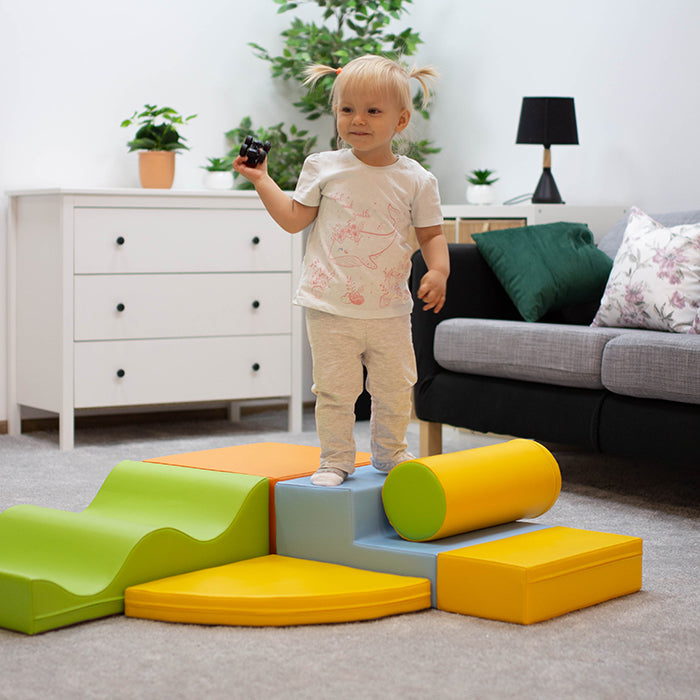 A little girl standing on top of a Soft Play Set - Explorer by IGLU Soft Play.