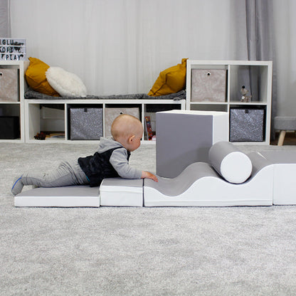 A baby boy crawling on an IGLU soft play set