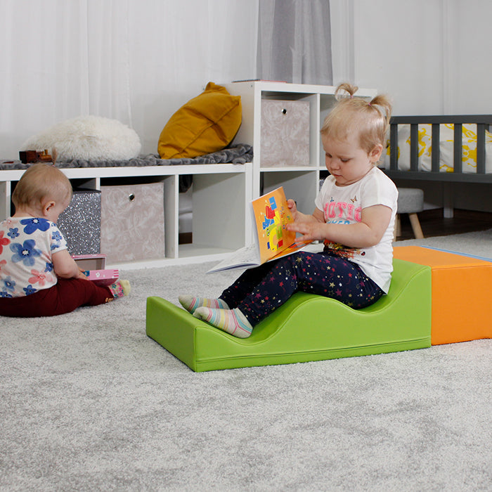 A baby is creatively balancing on the IGLU Soft Play - Wave Walk toy.