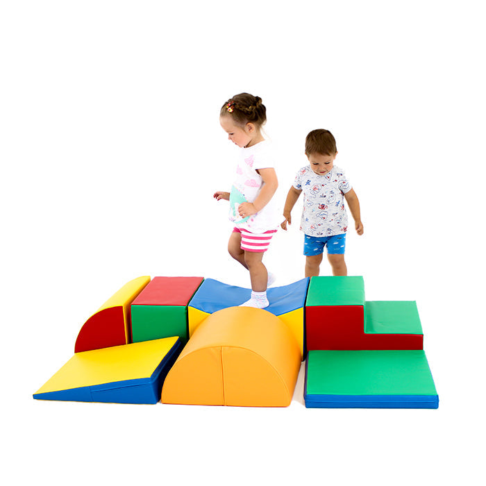Two children developing coordination and gross motor skills while playing on a Soft Play Activity Set - Adventurer XL from the IGLU Soft Play brand.
