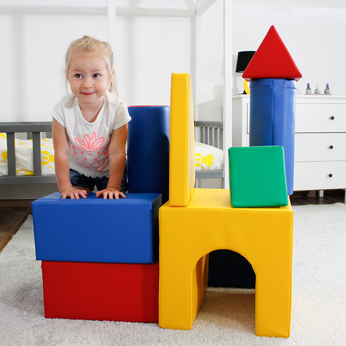 A little girl playing on top of an IGLU Soft Play - Castle toy castle.