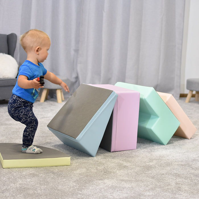 A baby is developing gross motor skills and coordination while playing with IGLU Soft Play's Soft Play Foam Block Set - Corner Climber in a living room.