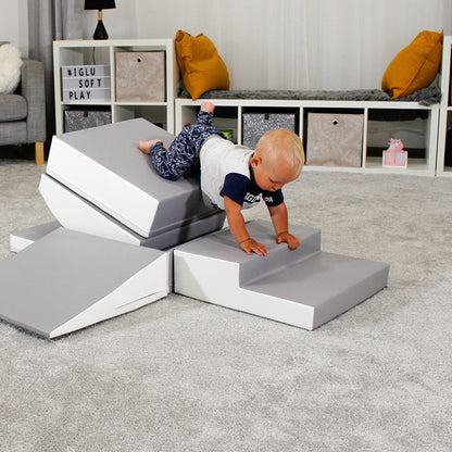 A baby is engaging in interactive play on an IGLU Soft Play - Little Crawler XL play mat, promoting physical development.