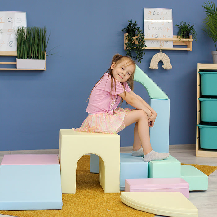A little girl engaged in imaginative play on IGLU Soft Play's Multifunctional Foam Play Set - Creativity.