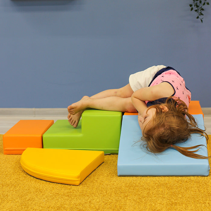 A little girl climbing on a stack of IGLU Soft Play - Two Way Crawler blocks.